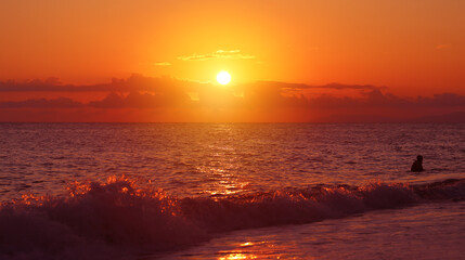 Photo of a beautiful rock and rough sea at sunset