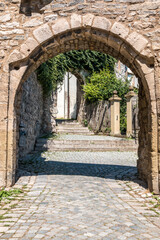 Fototapeta na wymiar A gate made of stones near the church