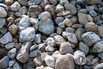 a heap of large stones in sunlight