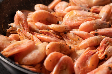 Prawns frying on a pan (closeup view)