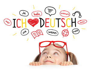 Beautiful cute little girl with eyeglasses looking at ich liebe deutch text (English translation: I...