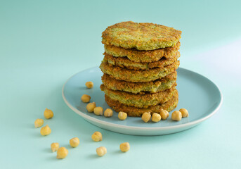 A stack of veggie burgers with chickpeas and vegetables on a blue background. Vegetarian food concept. Copy space.