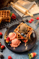 Waffles with ice cream, caramel sauce and fresh berries. Delicious Waffle with berry and ice cream at cafe.