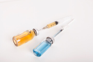 Syringes and medicine bottles on a white background.