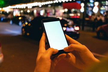 Mobile phone in female hands at night