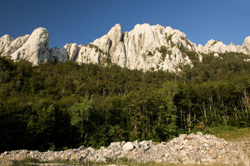 Hiking Velebit mountain in Croatia in summer, Velebit peaks Visibaba Kiza, Bacic kuk mountain rocks at Dabarski kukovi