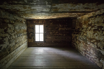 Empty barren room with sunlight streaming through the window. This is a historical structure within a national park and not a private property or residence. 