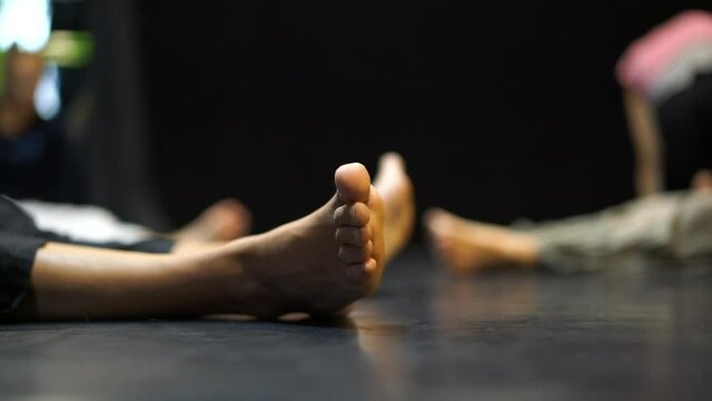 A close up of a dancers foots on floor in slow motion on blurred background