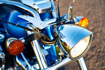 Chrome motorcycle headlight close-up.