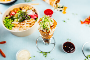 A flat lay of pizza cones and snack boxes