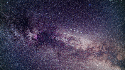 Perseid meteors visible over milky way background in region near Cygnus constellation