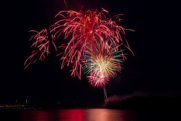 Volleys of fireworks over a large city. Recreation and entertainment concept.