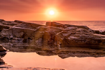 tidepool at sunset with reflection