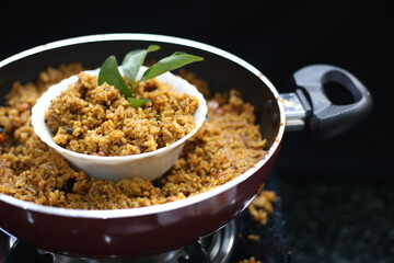 Puliyogare rice in the cooking pan with bowl, yellow color indian rice