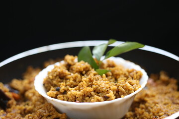 Puliyogare rice in the cooking pan with bowl, yellow color indian rice