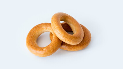 pile of dried baked golden bagels isolated on white background