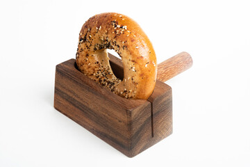A Freshly Baked Bagel On A Wood Slicing Stand