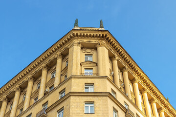 Old Stalin - era house with columns, against a blue sky