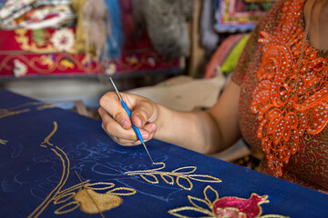 Uzbek woman making embroidery, in Bukhara, Uzbekistan