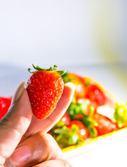 Delicious red strawberries served on a plate, ready to be used in smoothies, salads or tasted one by one