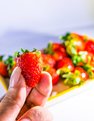 Delicious red strawberries served on a plate, ready to be used in smoothies, salads or tasted one by one