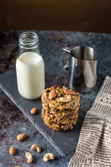 Oatmeal cookies with milk on table. Chocolate chip cookies with milk. Healthy food and drink and natural diet food. Cookie Almond and Cashew nuts.