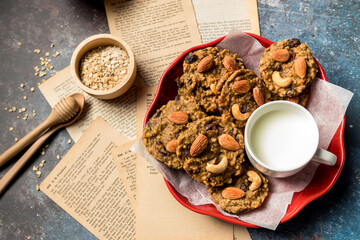 Oatmeal cookies with milk on table. Chocolate chip cookies with milk. Healthy food and drink and natural diet food. Cookie Almond and Cashew nuts.