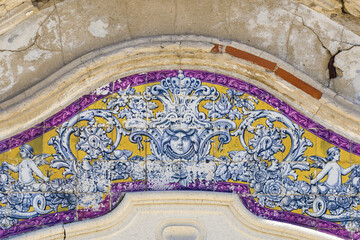 panels of polychrome azulejos on the walls of a beautiful ruined house in Setubal