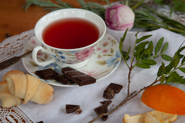 A cup of tea and cookies on a lace napkin