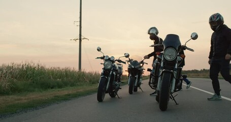 A group of bikers gets on motorcycles and starts the journey