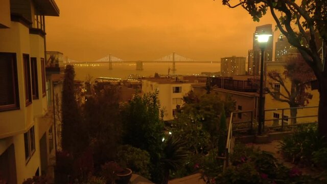 San Francisco Bay Bridge covered in a surreal orange smoky sky during the California wildfire
