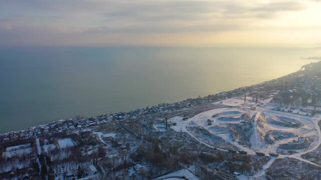 Aerial 4k view of Odessa city in winter with snow during sunset