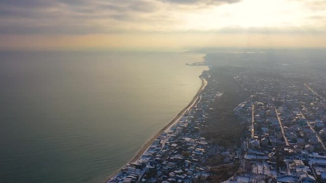 Aerial 4k view of Odessa city in winter with snow during sunset