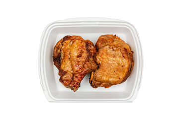 Grilled pork loin in a white box, top view, isolated