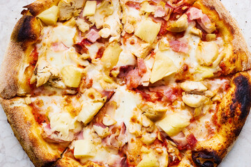 Italian oven pizza with chicken fillet and pineapple with burnt edges Traditional food 