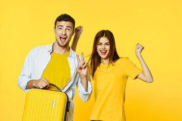 A happy man and his girlfriend go on a trip with a suitcase 