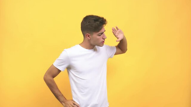 Young caucasian student man whispering gossip undertone, trying not to be heard