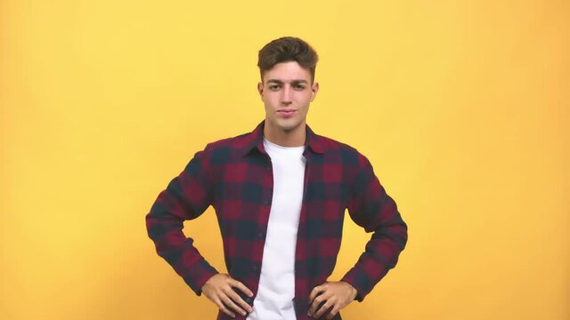 Young caucasian student man winking, funny joke, symbol of agreement or complicity