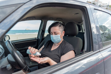 Woman applying Alcoholic Gel before driving. Protection.