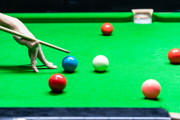 A man playing snooker in bar. Snooker player aiming snooker ball on snooker table.