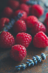 Some raspberry an lavender flower on a table