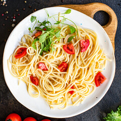 spaghetti pasta tomato salad vegetables macaroni semola durum wheat on the table serving size top view place copy space for text