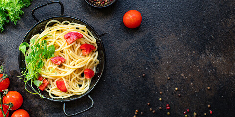 spaghetti pasta tomato salad vegetables macaroni semola durum wheat on the table serving size top view place copy space for text