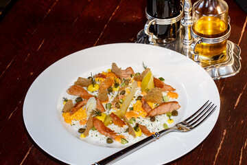 Rice with salmon slices and vegetables is on a plate
