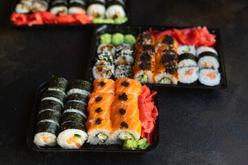 fresh sushi rolls salmon fish vegetables ginger wasabi rice and nori on the table serving size top view place copy space for text