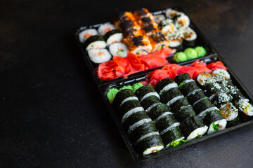 fresh sushi rolls salmon fish vegetables ginger wasabi rice and nori on the table serving size top view place copy space for text