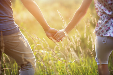 Close-up of people's hands. A man and a woman hold hands