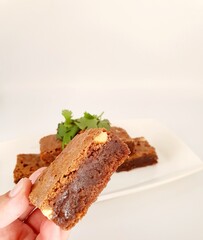 Close up of chocolate brownie on a white background. 