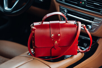 Women's handbag in the interior of a luxury car