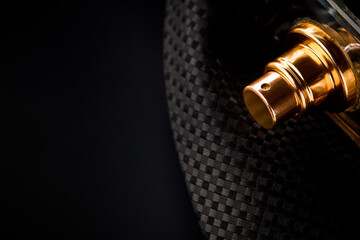 luxury male perfume bottle over black formal background. copy space. studio shot. low key. man wellbeing and glamour life concept